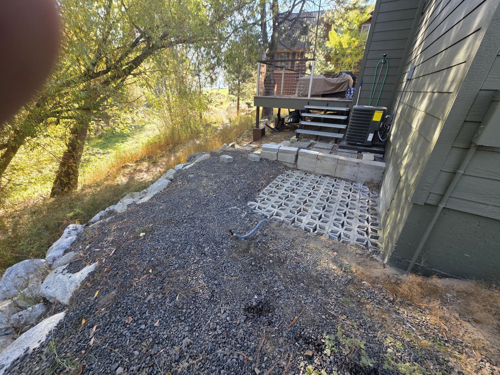 Patio area during the job: graded gravel and boulder edge